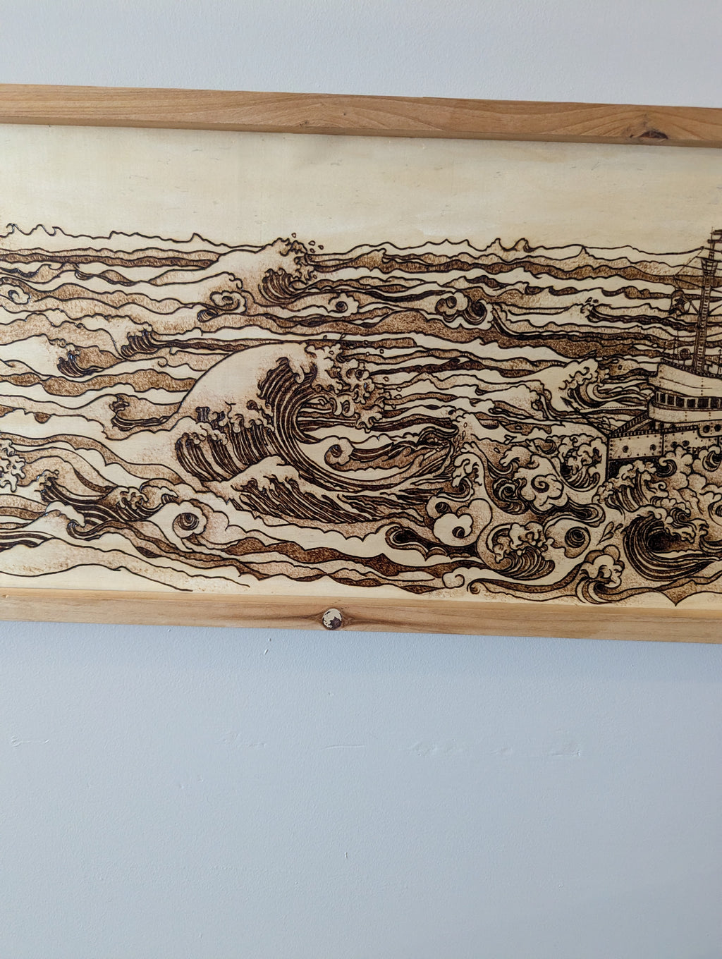 Hand drawn and wood burned artwork of the Edmund Fitzgerald